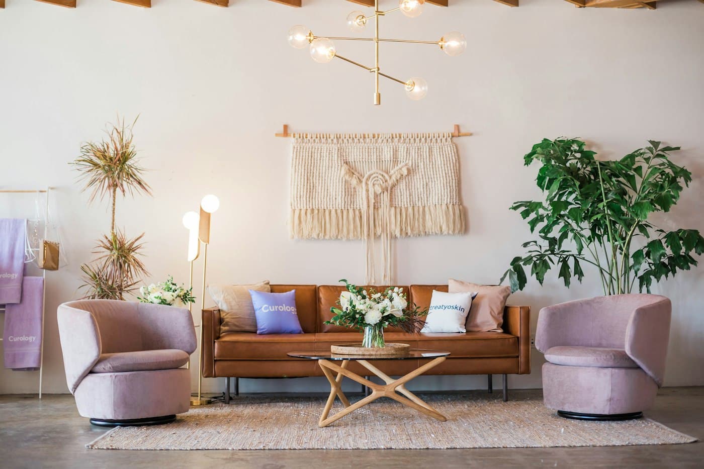 Living room with a tan sofa and two blush armchairs